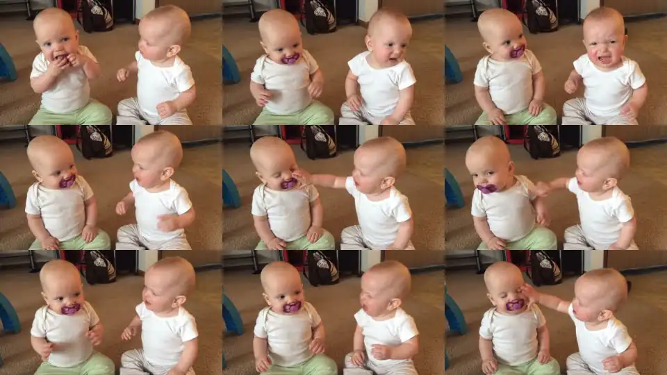 Twin baby girls fight over pacifier