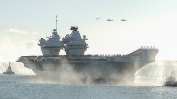 Military aircraft fly over HMS Prince of Wales during home-coming ceremony after 8 month deployment