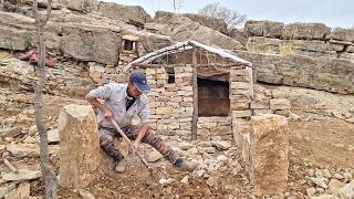 Building a survival shelter with a stone fireplace in the mountains for rain and snow