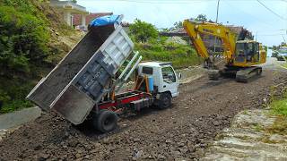 Engineering Deep Dive: Excavator Trucks Spreading Materials for Hill Road Repairs
